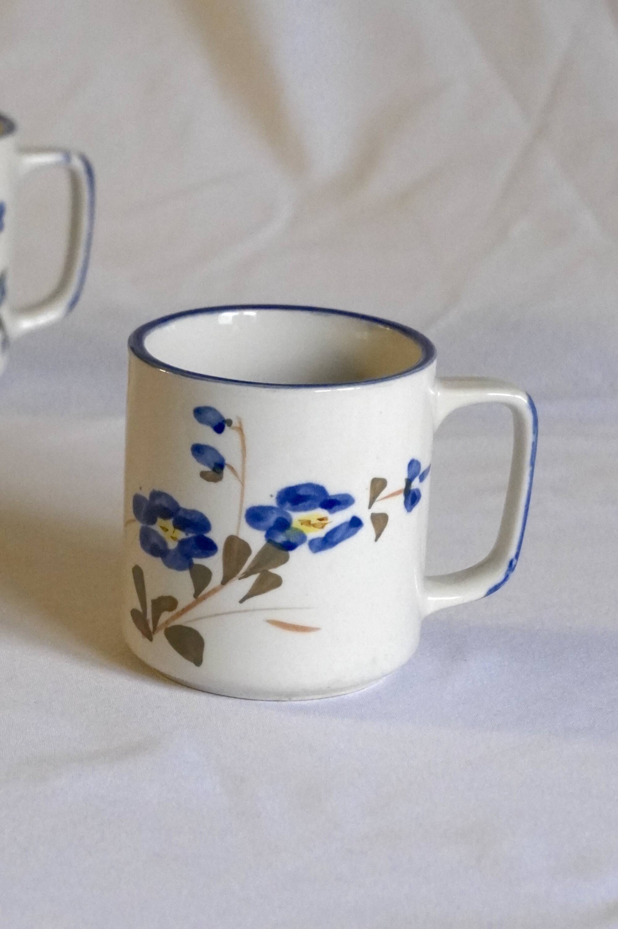 Set of 4 stoneware cups/mugs with blue floral designs, made in China.