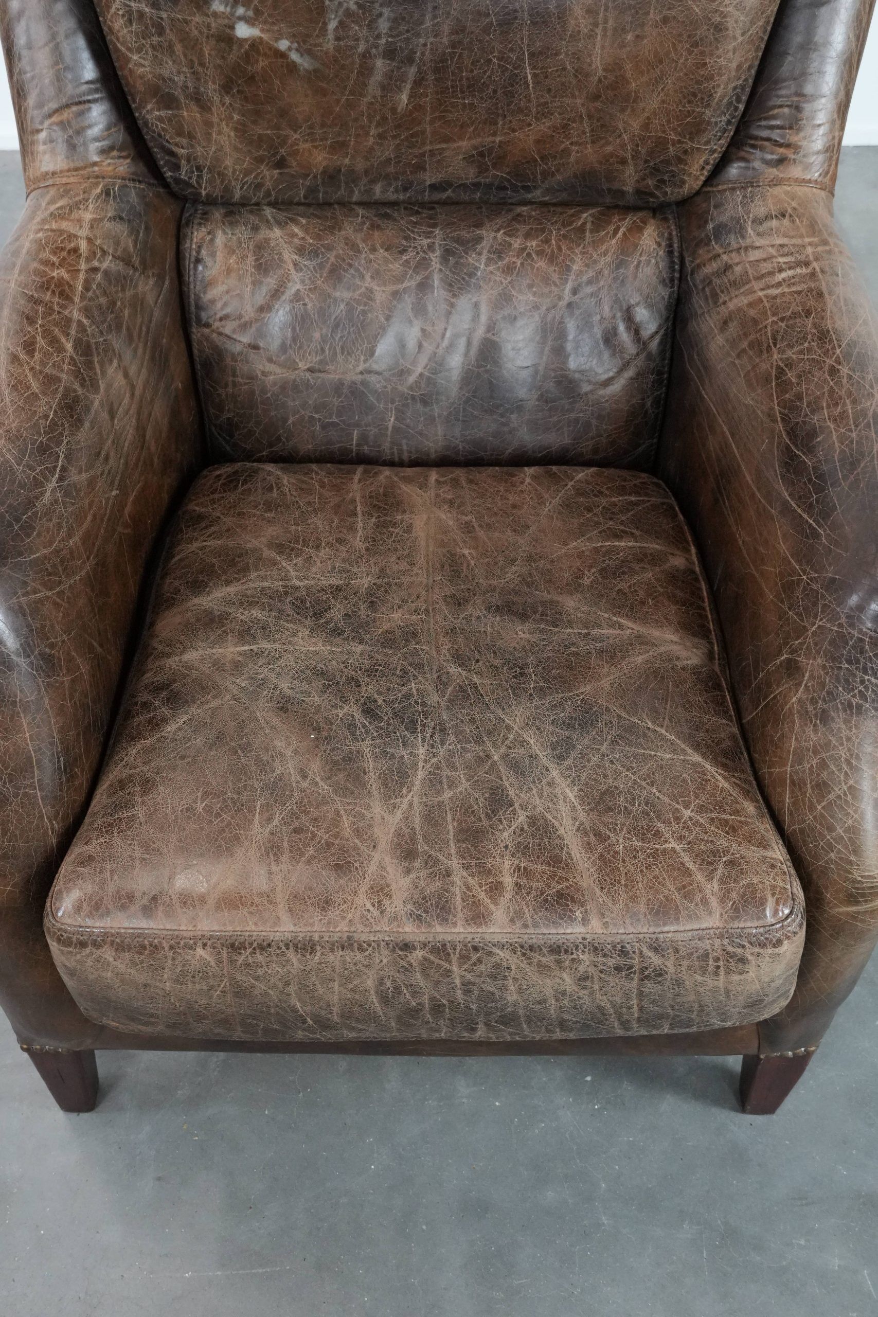 Very comfortable vintage cow leather armchair with character