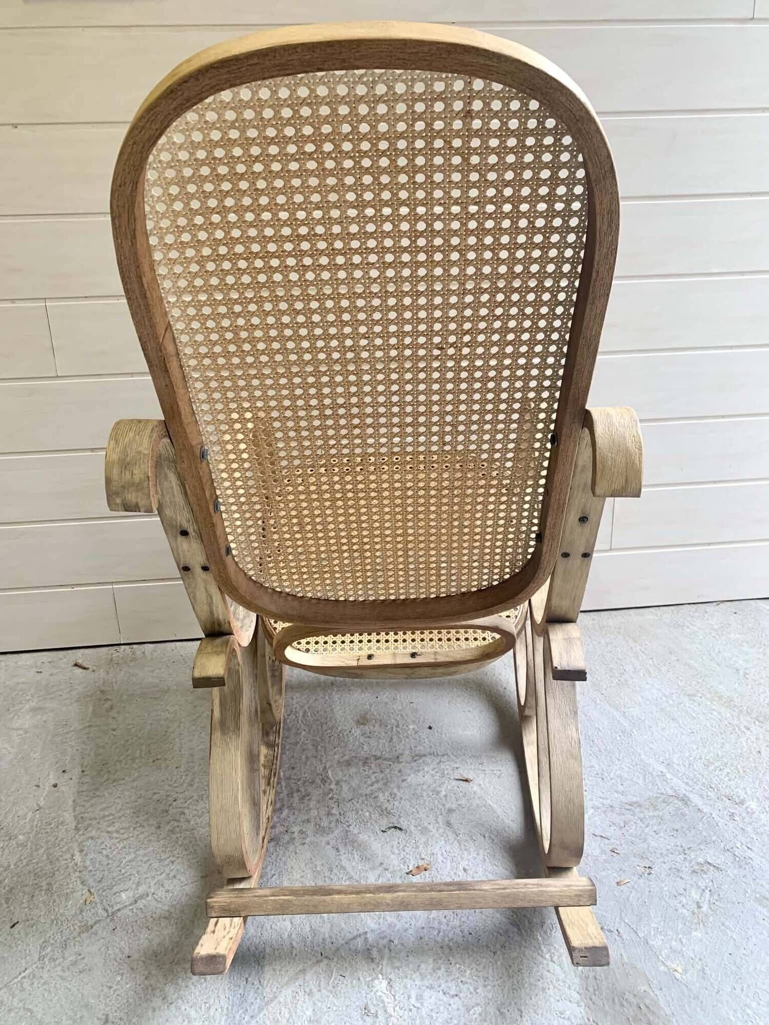 Rocking chair with a cane seat and backrest.