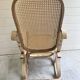 Rocking chair with a cane seat and backrest.