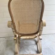 Rocking chair with a cane seat and backrest.