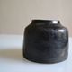 Ceramic vase with a signature fish to identify.