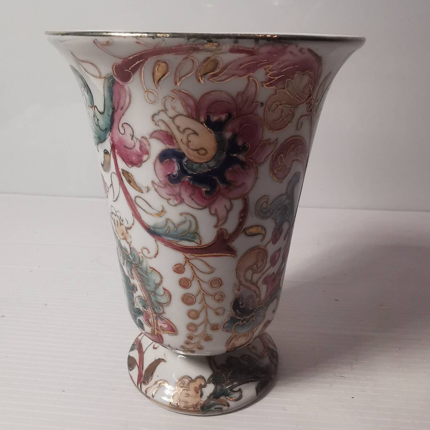 Old vintage vase with floral decor