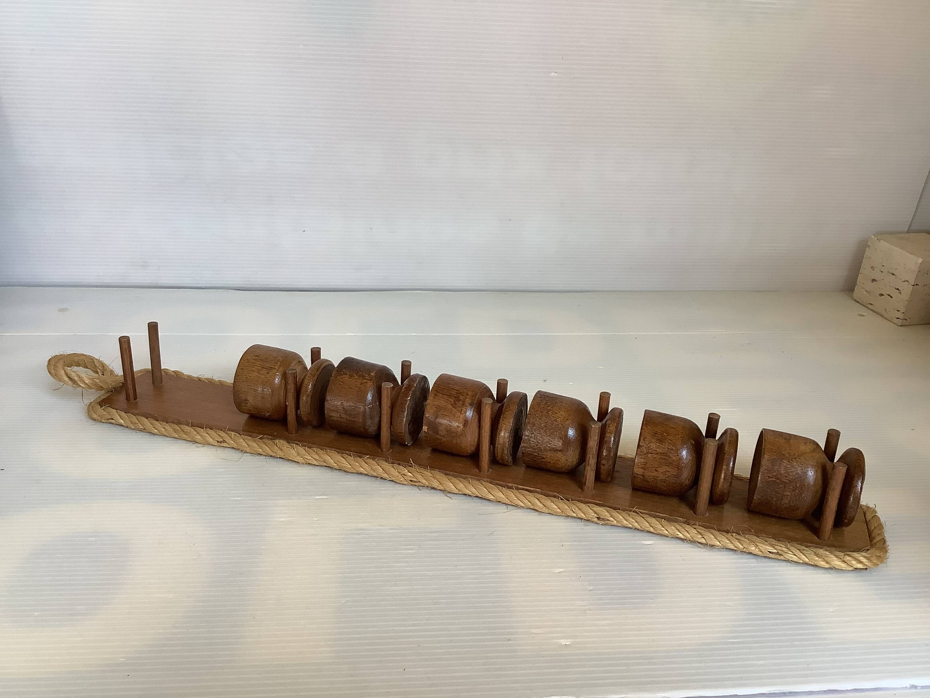 Six wooden egg cups and their rope holder