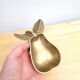 Pear-shaped pocket emptier in gilded brass