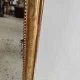 Long wooden mirror and gilded stucco with pearl rays H: 2m45 L: 40cm