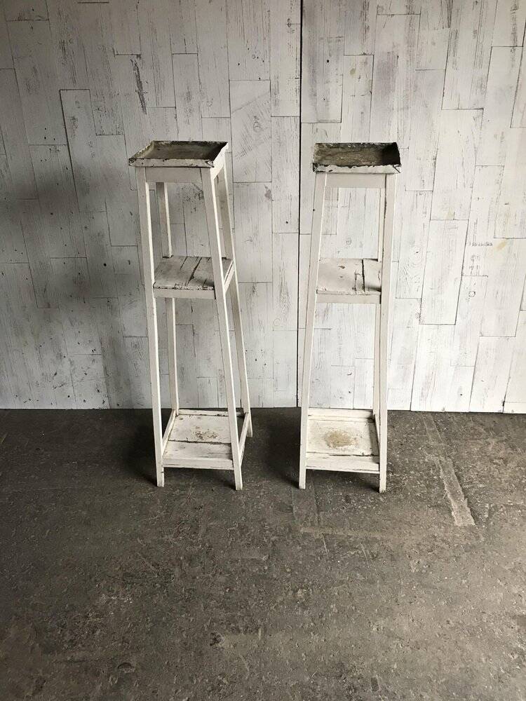 Two white vintage mid-20th century wooden plant stands, 3-tier shelves.