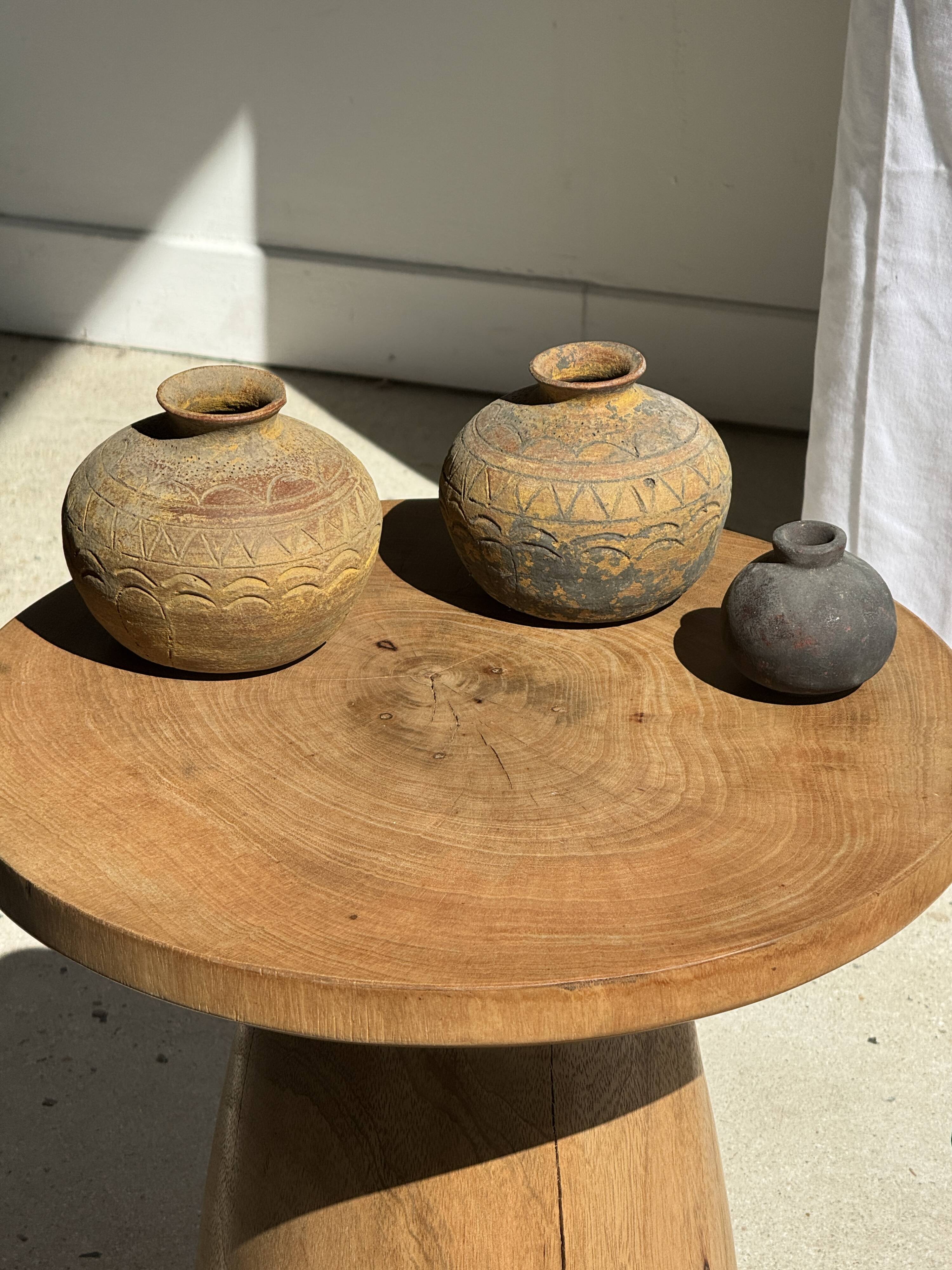 Natural solid mango side table (monoxyle) with conical legs.