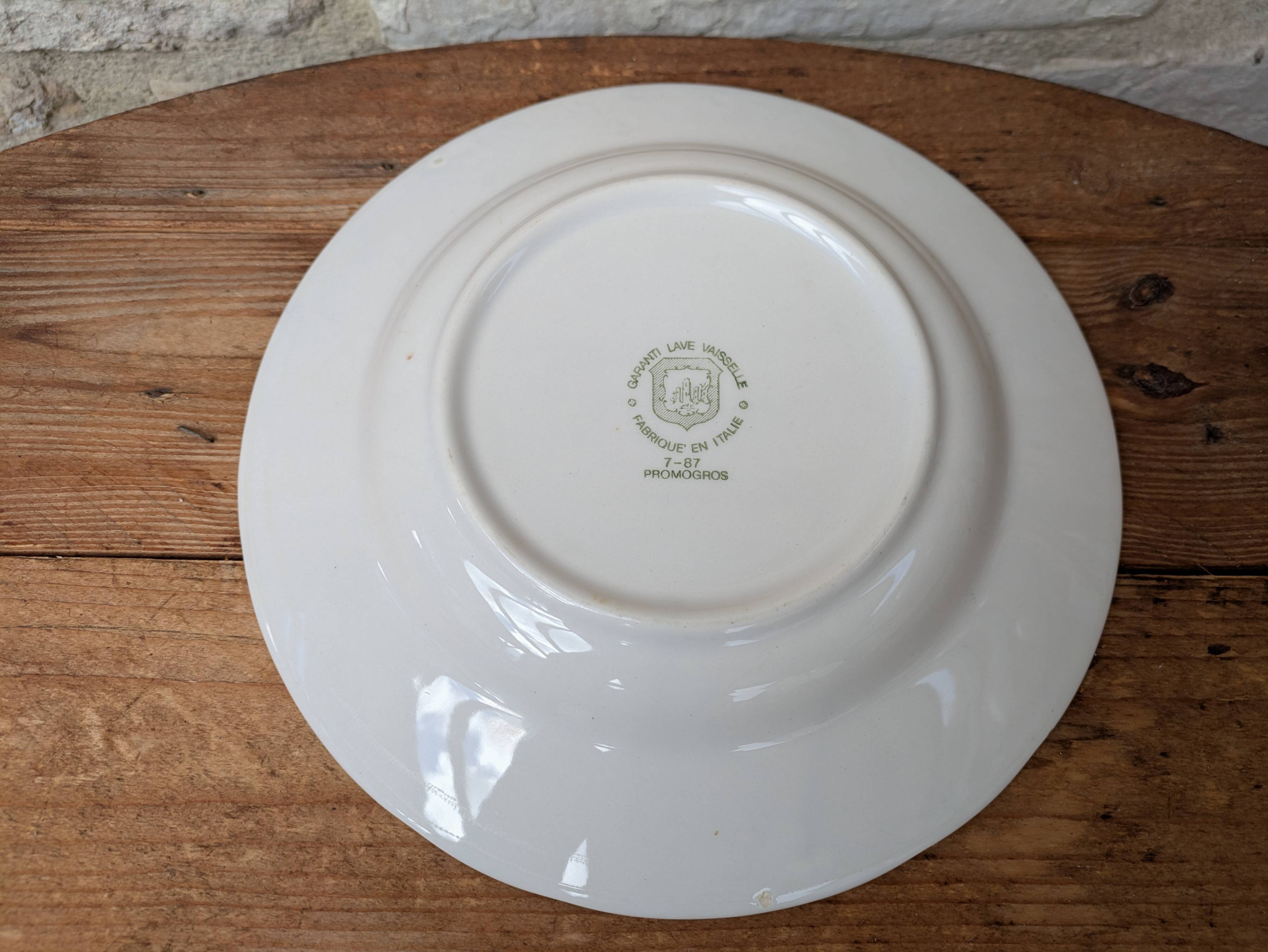 Old deep plate with blue floral pattern and gallant scene