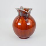 Large red and blue glazed ceramic pitcher signed Delène under the base