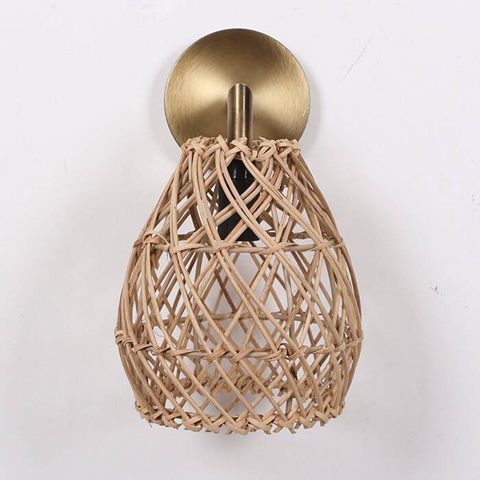 Golden bohemian wall lamp in woven rattan