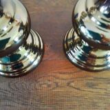 Two bronze-colored candlesticks