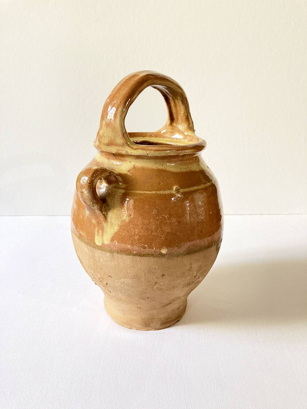 Old ochre and yellow glazed ceramic jug / goat