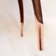 Round Art Deco side table in wood with curved legs and brass feet.