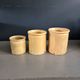 Trio of ancient pots in yellow glazed terracotta.