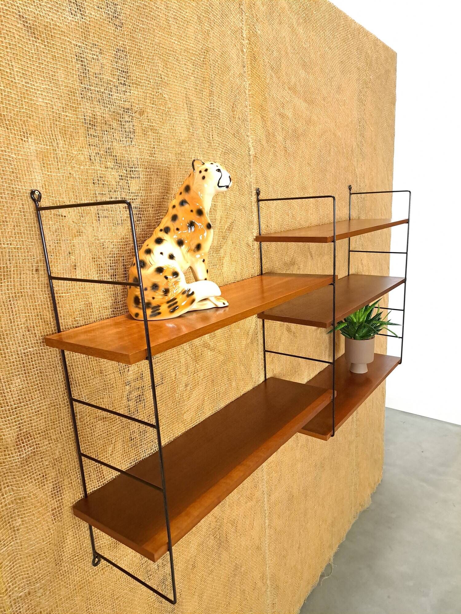 Wall rack with shelves and steel holders, dark wall system