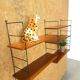 Wall rack with shelves and steel holders, dark wall system