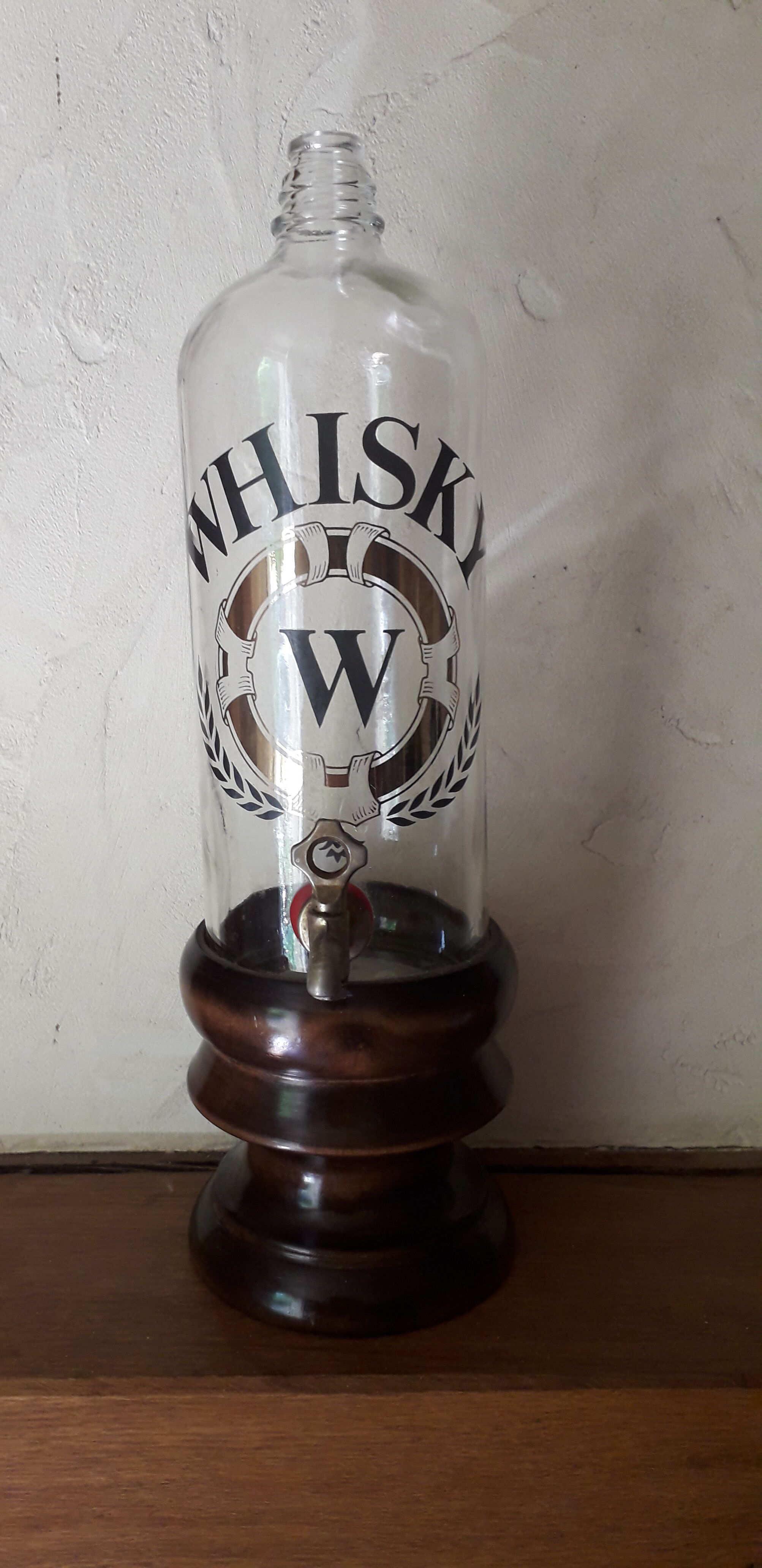 Vintage glass and wood whiskey bottle with pouring tap
