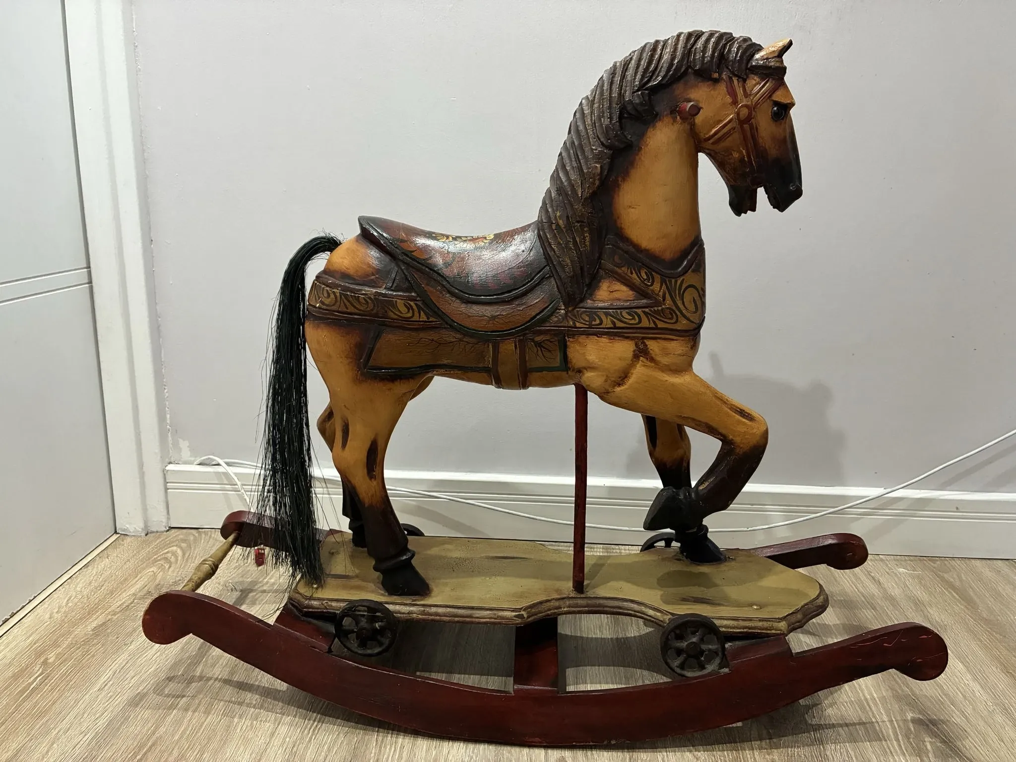 Antique hand-carved rocking horse on wheels, early 20th century
