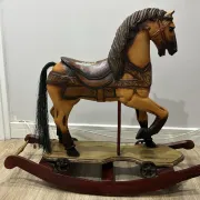Antique hand-carved rocking horse on wheels, early 20th century