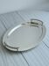 Oval metal tray in silver white.