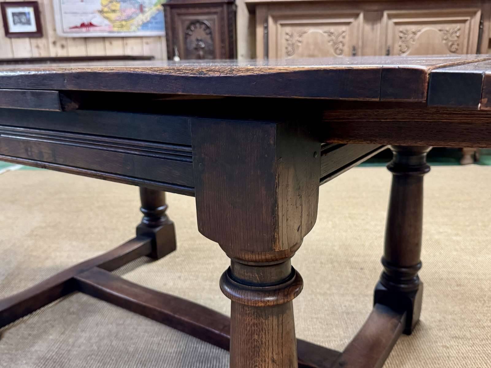 English monastery table with extensions from the late 19th century in elm and oak.