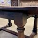 English monastery table with extensions from the late 19th century in elm and oak.