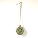 Green ball marine float in glass and rope
