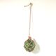 Green ball marine float in glass and rope