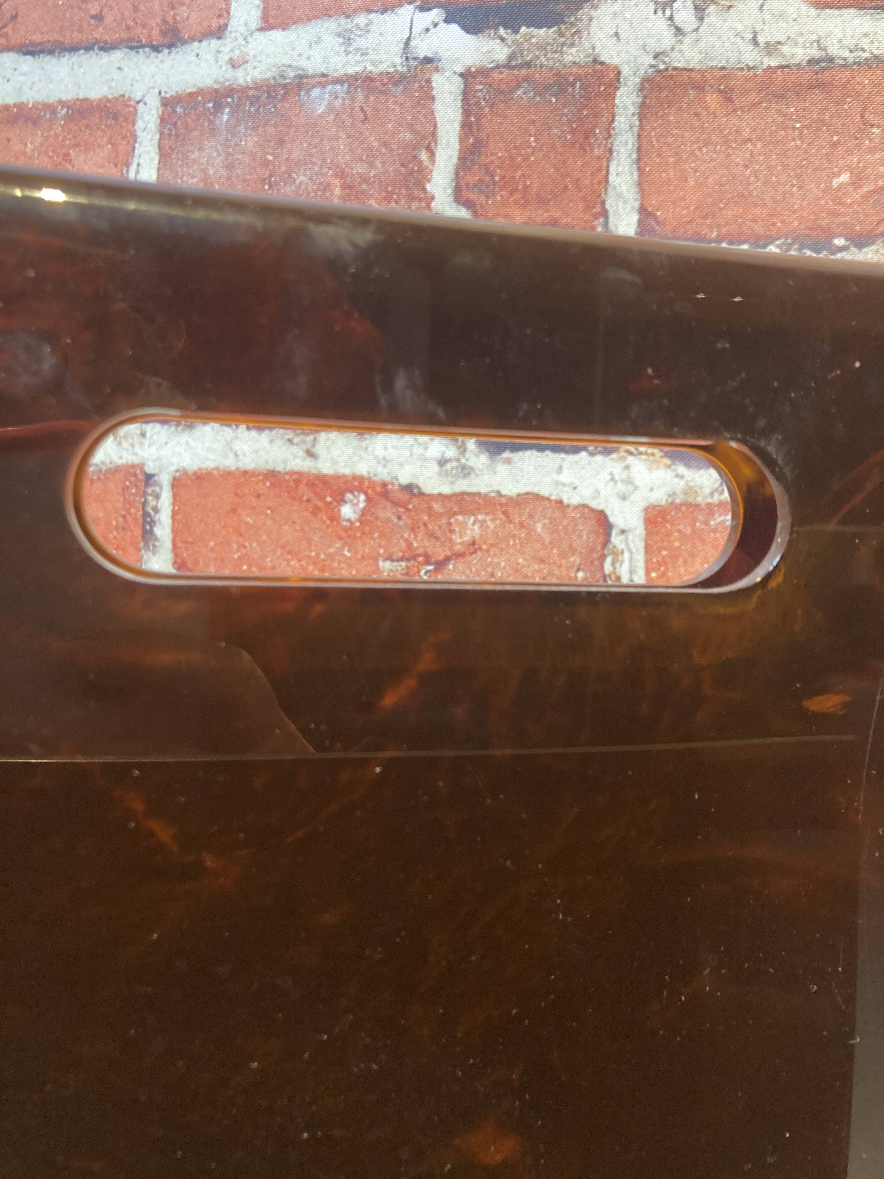 Brown plastic magazine holder with handle