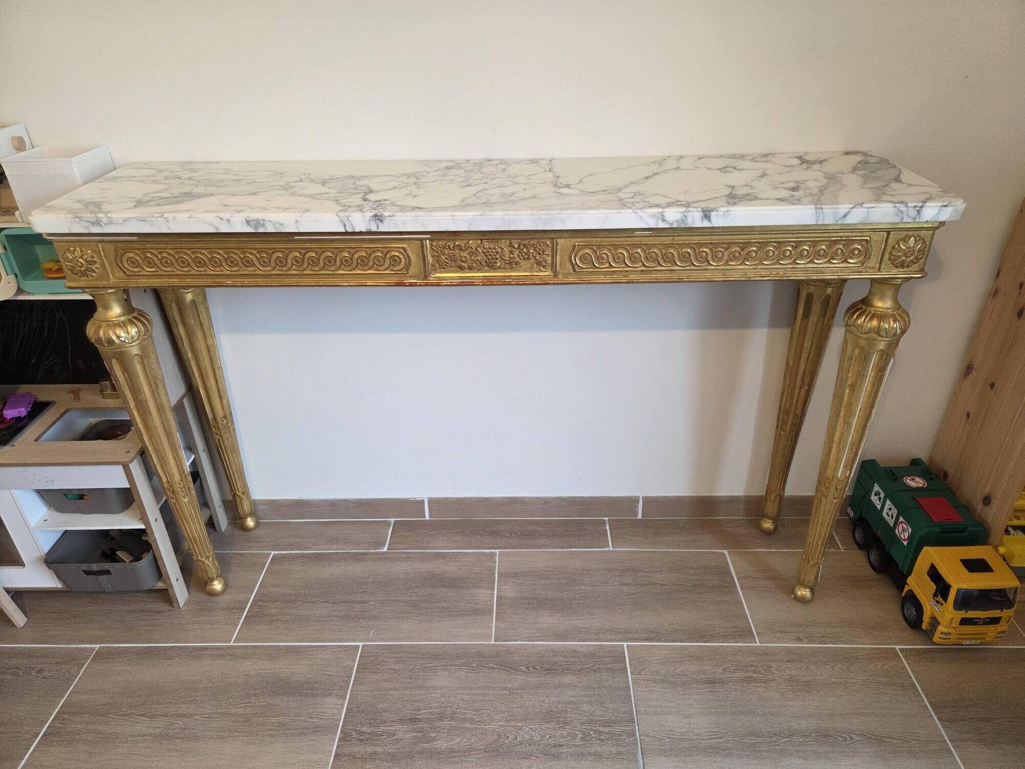 18th-century Italian console in gilded wood with a marble top.