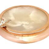 1970s Onyx ashtray with a gold metal rim.