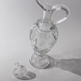 Vintage pressed glass carafe from the 1960s, clear sculptural glass with textured patterns and a stopper.