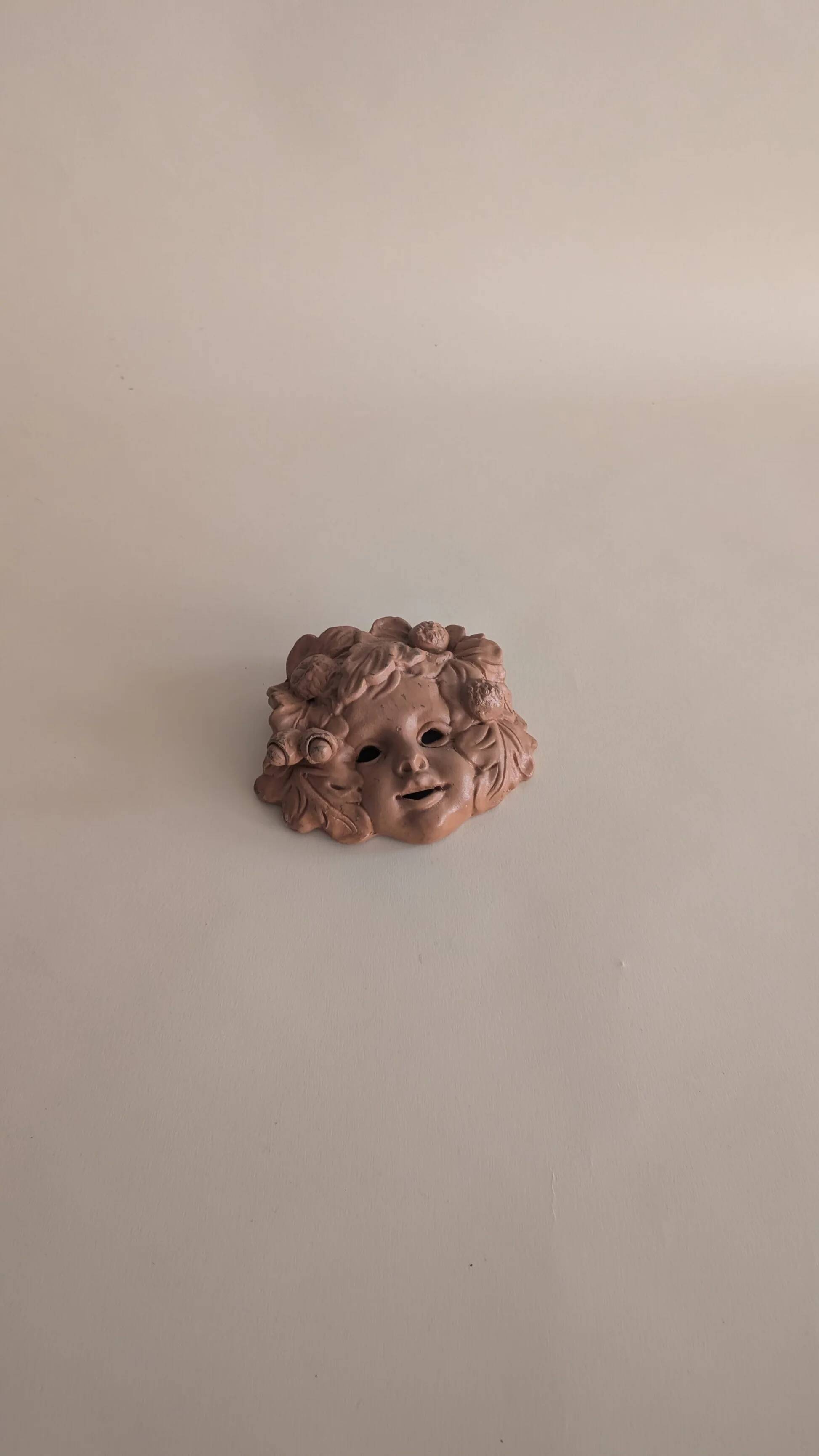 Vintage terracotta wall mask - flowery child's face