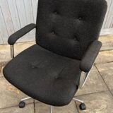 Black mottled fabric and chrome swivel armchair, 1