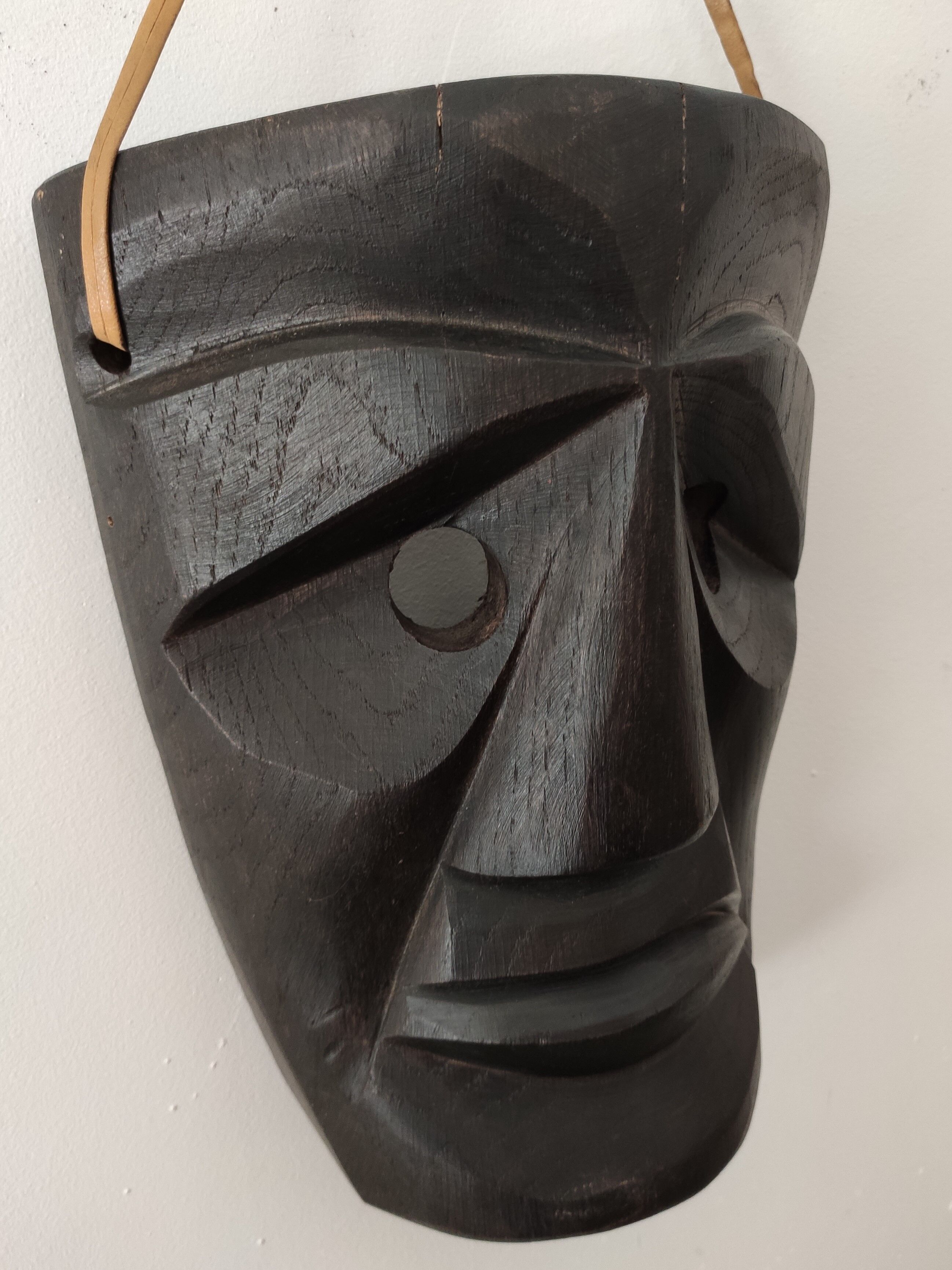 Ethnic ebony wood mask for display or hanging.