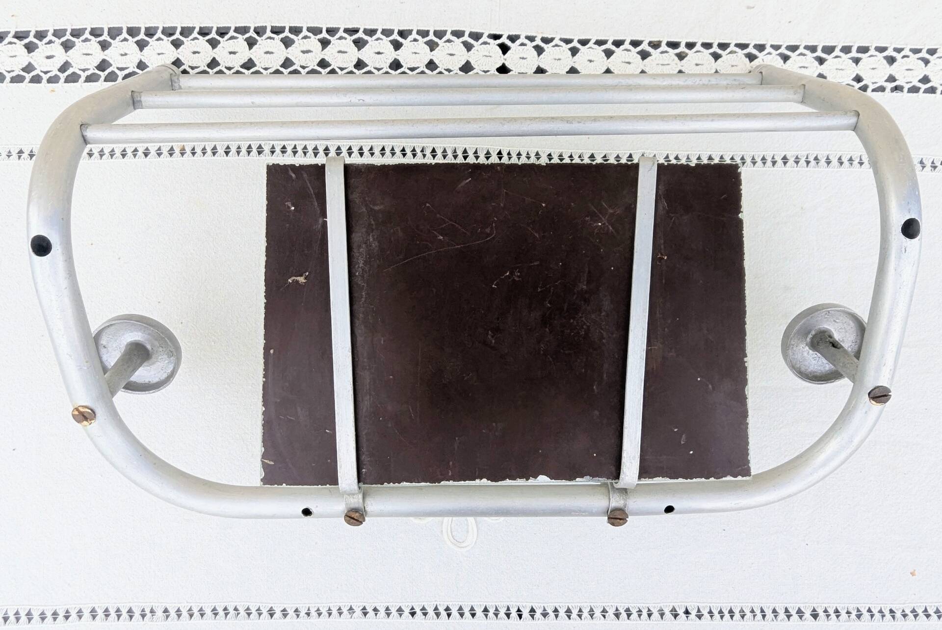 Vintage train style wall-mounted hat rack with angled mirror.