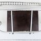 Vintage train style wall-mounted hat rack with angled mirror.