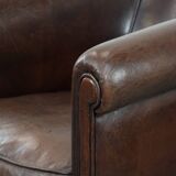 Stylish and sturdy dark brown club armchair made of sheepskin leather