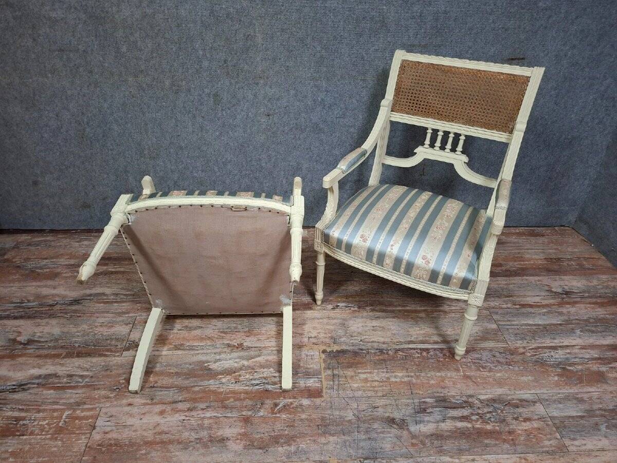 a pair of caned armchairs in the Louis XVI style, elegant and full of charm.