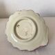 Antique slip candlestick depicting a flower