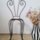 Small chair / stool in twisted wrought iron and floral ceramic.