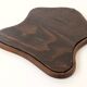 Antique wall mirror in carved wood with a wavy shape and a golden trim.