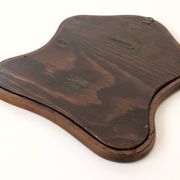 Antique wall mirror in carved wood with a wavy shape and a golden trim.