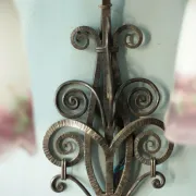 Wall lamp in wrought iron with a pink tulip glass globe by Muller glassworks.