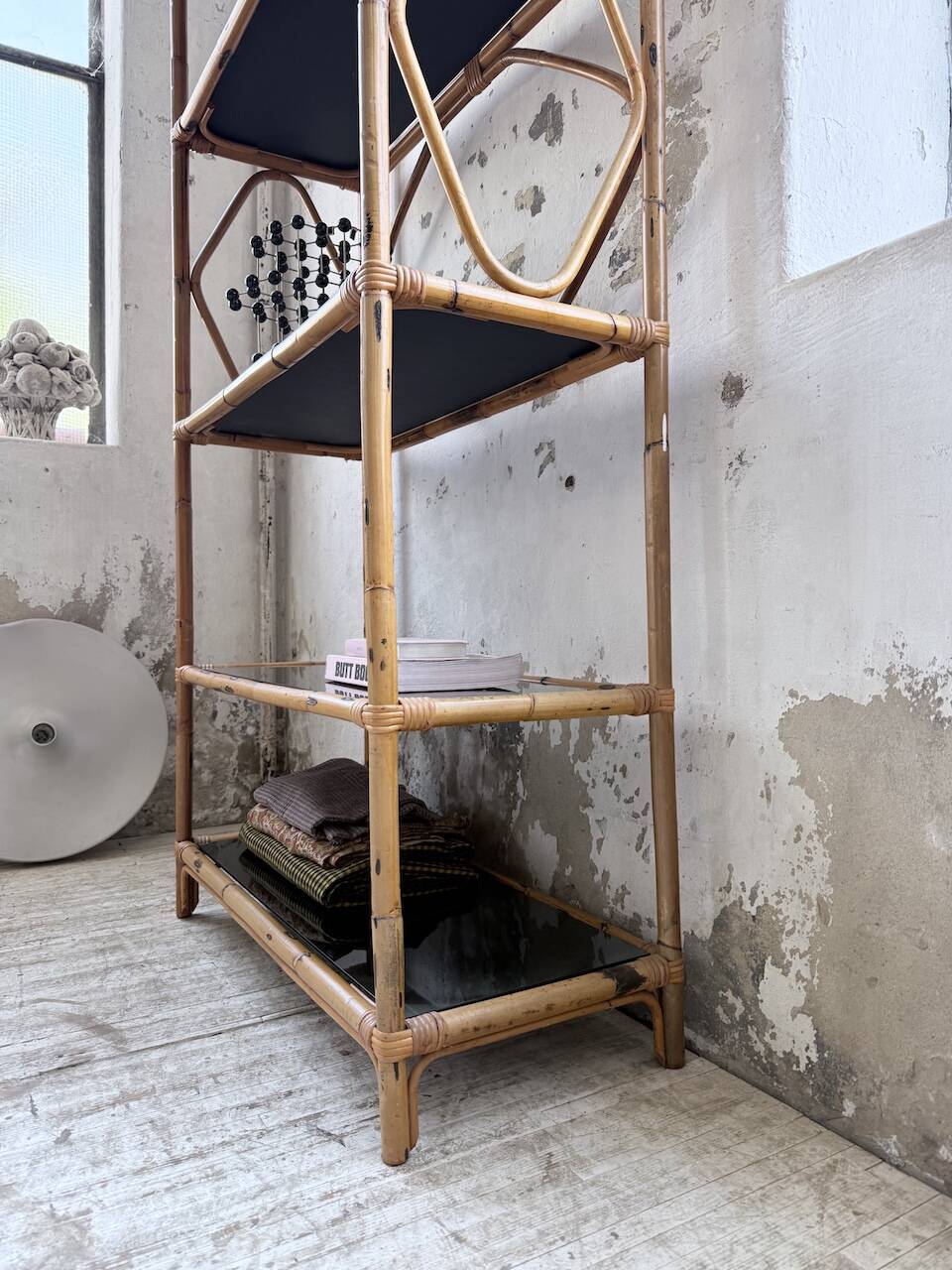 Rattan bookshelf and black glasses