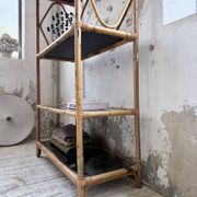 Rattan bookshelf and black glasses