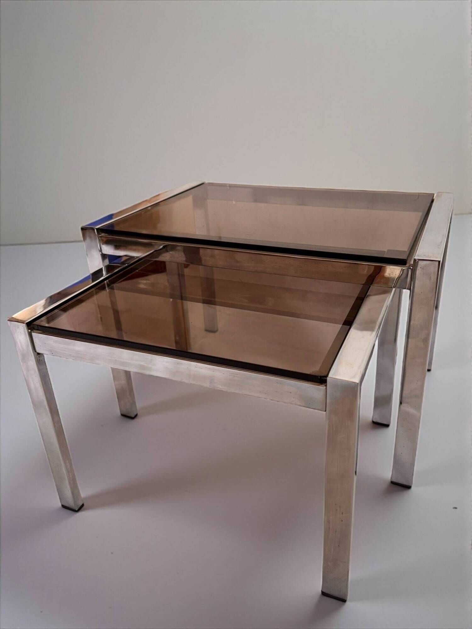 Vintage 1970s nesting tables in chrome and smoked glass, mid-century modernist style
