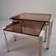 Vintage 1970s nesting tables in chrome and smoked glass, mid-century modernist style