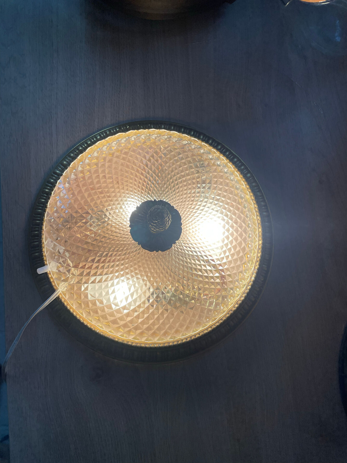 Antique ceiling light in bronze and cut crystal with diamond points.